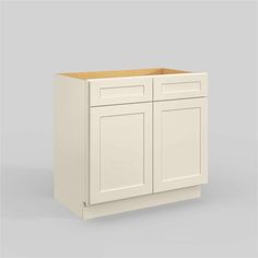 a white cabinet with two doors and one drawer on the bottom, in front of a gray background