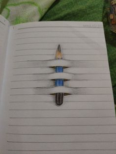 an open notebook with two pencils sticking out of the top and bottom of it