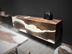 a wooden sideboard with two vases on top of it in a living room