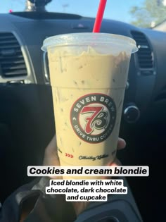 a person holding up a cup of ice cream in their hand with the words cookies and cream blondie on it