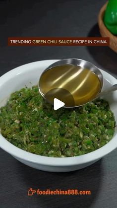 a white bowl filled with green sauce and a spoon