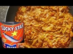 a pan filled with food next to a can of lucky star sauce on top of a table