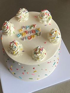 a birthday cake with white frosting and sprinkles