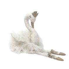 a white swan doll laying on the ground