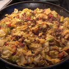 a pan filled with food sitting on top of a stove