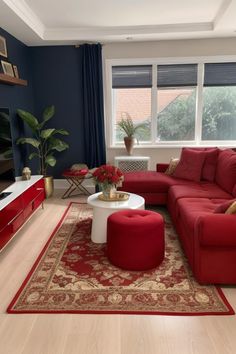 a living room with blue walls and red furniture