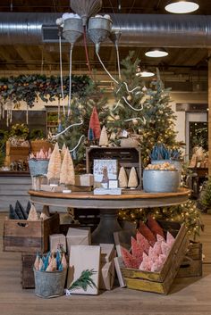 an assortment of holiday treats on display in a store with christmas trees and other decorations