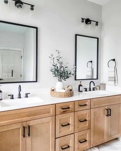 a bathroom with double sinks and mirrors on the wall