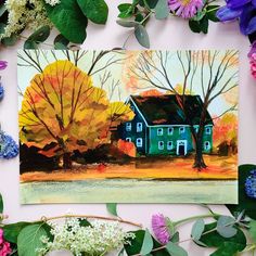 a painting of a blue house surrounded by flowers