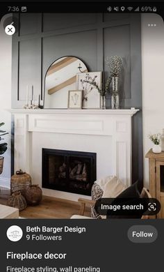 a living room with fireplace and mirror above it