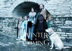 a group of people and a dog standing in front of a stone wall with the words winter is coming