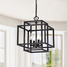 a black chandelier hanging from a ceiling