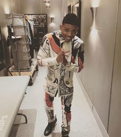 a young man standing in an office hallway