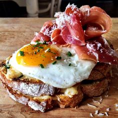 an egg on toast with bacon and cheese