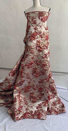 a dress on a mannequin with red flowers