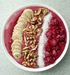 a bowl filled with fruit and nuts on top of a table