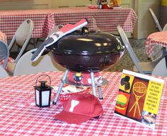 a red and white checkered table with a grill on it