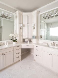 a large bathroom with two sinks and mirrors