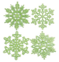 four green snowflakes are shown on a white background, each with different shapes and sizes