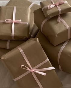 several brown wrapped presents with pink ribbons