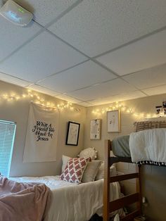 a bedroom with two bunk beds and lights on the ceiling