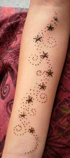 a woman's arm with stars on it