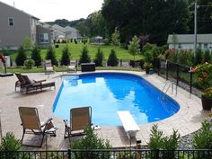 an empty swimming pool surrounded by lawn chairs