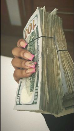 a woman's hand holding a stack of cash with pink nails on it and the words cool written in front of her