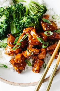 chicken and broccoli served with rice on a plate next to chopsticks