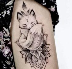 a black and white photo of a tattoo with a fox on it's arm