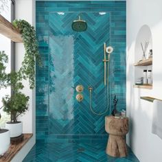 a bathroom with blue tiles on the shower wall and wood flooring, along with potted plants