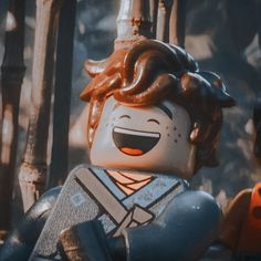 a close up of a lego figure with an evil look on his face and hair