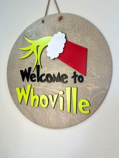 a welcome sign hanging from the side of a wall