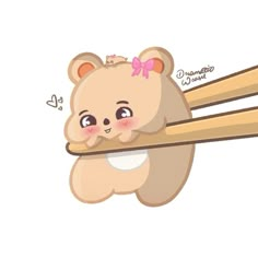 a cute little bear holding on to some chopsticks