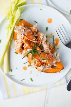 a white plate topped with food next to a fork