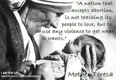 a woman holding a baby in her lap with a quote from mother teresa