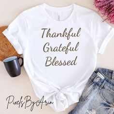 This "Thankful Grateful Blessed" T-shirt is perfect for spreading positivity and inspiration. Featuring a motivational quote, it makes a great addition to your casual wear collection. Whether you're going out for a walk or just lounging at home, this shirt will remind you to stay thankful, grateful, and blessed. It also makes a thoughtful gift for friends and loved ones who appreciate positive messages. 🌟 Elevate your wardrobe with our Unisex Classic T-Shirt, designed to be your new go-to favorite! Made from premium quality materials, this soft and breathable tee is perfect for any occasion, whether you're dressing up for a casual outing or lounging at home. 🌟Key Features: 🌟Material: Crafted from 100% Airlume combed and ring-spun cotton for unparalleled comfort. (Fabric blends may vary Message Positif, Spreading Positivity, Thankful Grateful Blessed, Grateful Thankful Blessed, Quote Tees, Positive Messages, Inspirational Quote, Classic T Shirts, Casual Wear