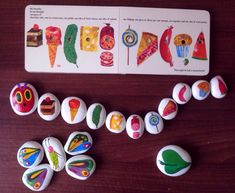 a group of buttons sitting on top of a wooden table next to a piece of paper