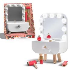 a white vanity with lights and mirror in front of a cardboard box on the floor