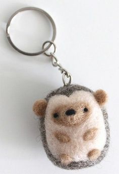 a needle - felt hedge keychain is shown on a white surface with a silver ring