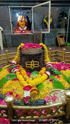 there is a large cake decorated with flowers and other things on the table in front of it