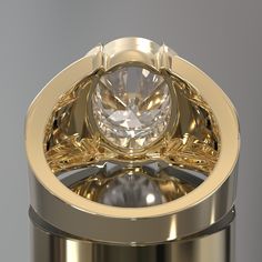 a gold ring with a large diamond in it's center and two smaller diamonds on the side