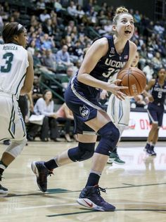 a women's basketball player dribbling the ball