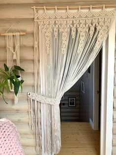 a room with wooden walls and white curtains