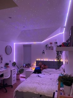 a bed room with a neatly made bed and purple lights