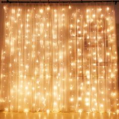 a curtain with lights on it in front of a window