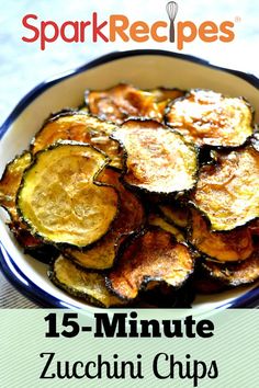 a bowl filled with fried zucchini chips on top of a table