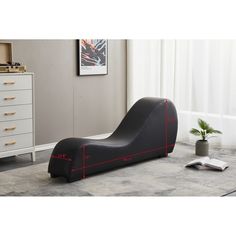 a black chaise lounger with red lines on the side and measurements for it