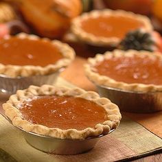 several pies sitting on top of a wooden table