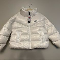 Womens Nike Coat Size: Large This Women’s Nike Coat Is Brand New With Tags. It Is An Absolute Must Have And Perfect For Your The Winter. Please Review All Pictures Before Making Your Purchase. If You Have Any Questions About This Item Please Email Me. White Winter Outerwear With Detachable Hood, Winter Sports Long Sleeve Puffer Jacket, Fitted Hooded Sportswear Outerwear, White Down Puffer Outerwear, White Fitted Hooded Jacket For Winter, Fitted White Hooded Winter Jacket, Fitted White Hooded Jacket For Winter, Nike Winter Sports Outerwear, White Nike Hooded Jacket